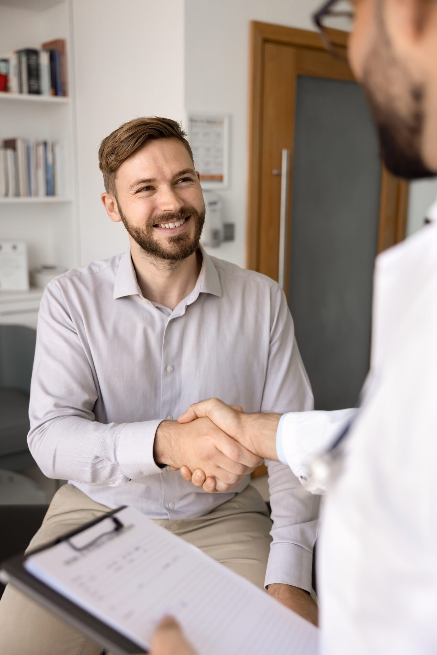 A patient shaking hands with a healthcare professional, representing the trusted partnership and continuity of care for TMS therapy, Spravato, and medication management at our compassionate psychiatric services clinics in our Frisco and Sherman locations.